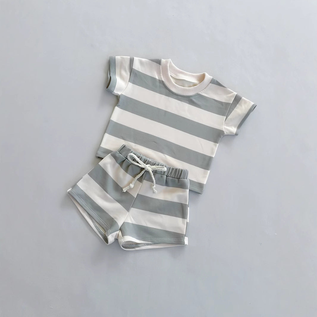 ベビーモデルがブラウンチェック柄の服で遊んでいる自然なシーン