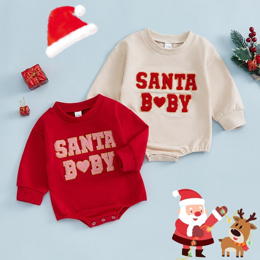 christmas baby romper with embroidered santa baby lettering on apricot cotton fabric