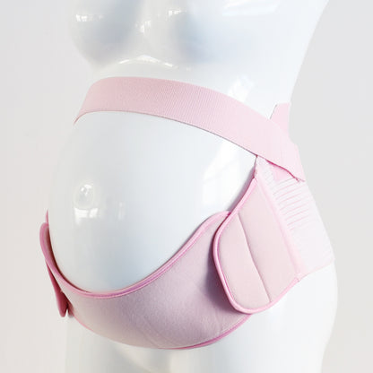 Flat lay of black maternity belly support belt on white background
