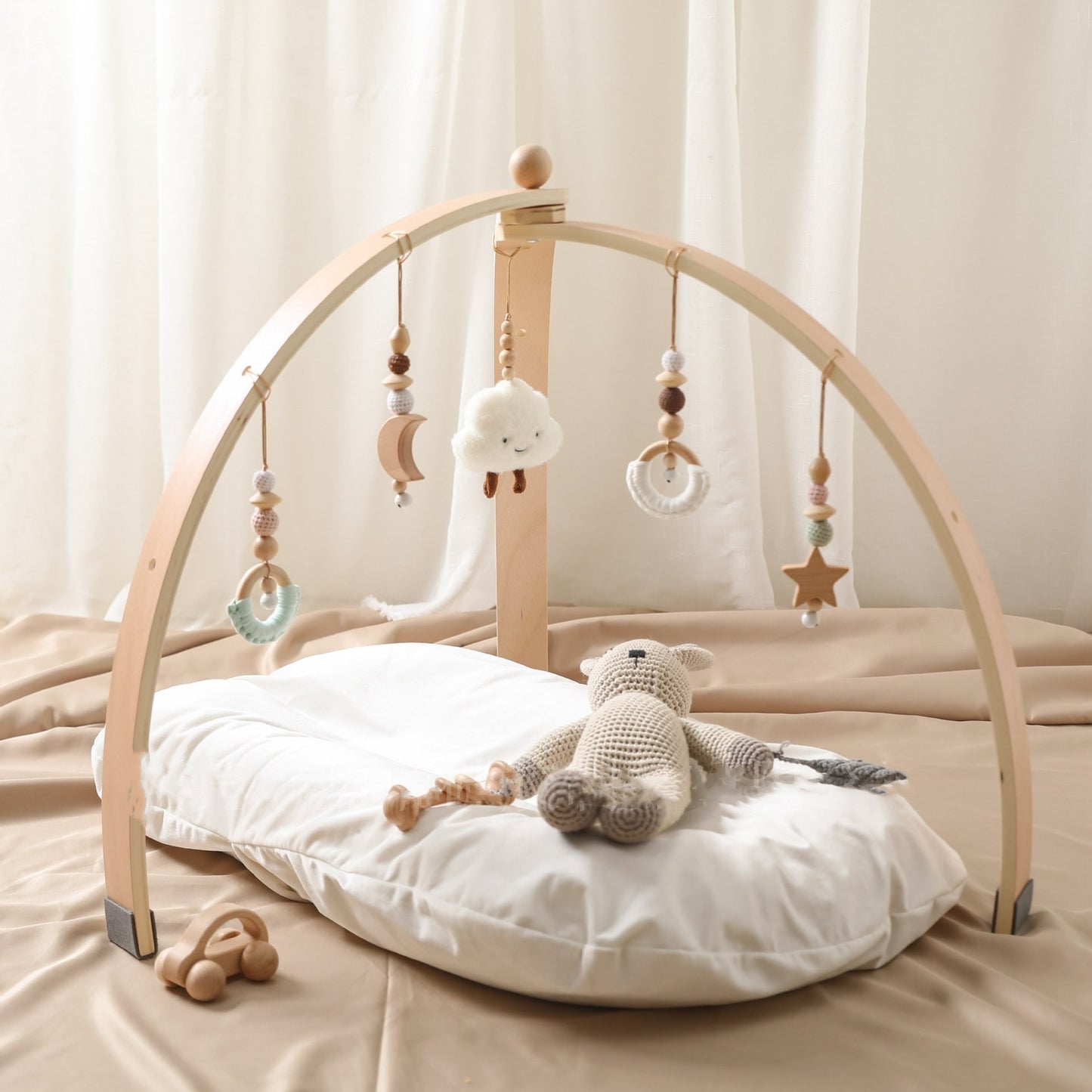 wooden baby gym with hanging toys, natural wood design